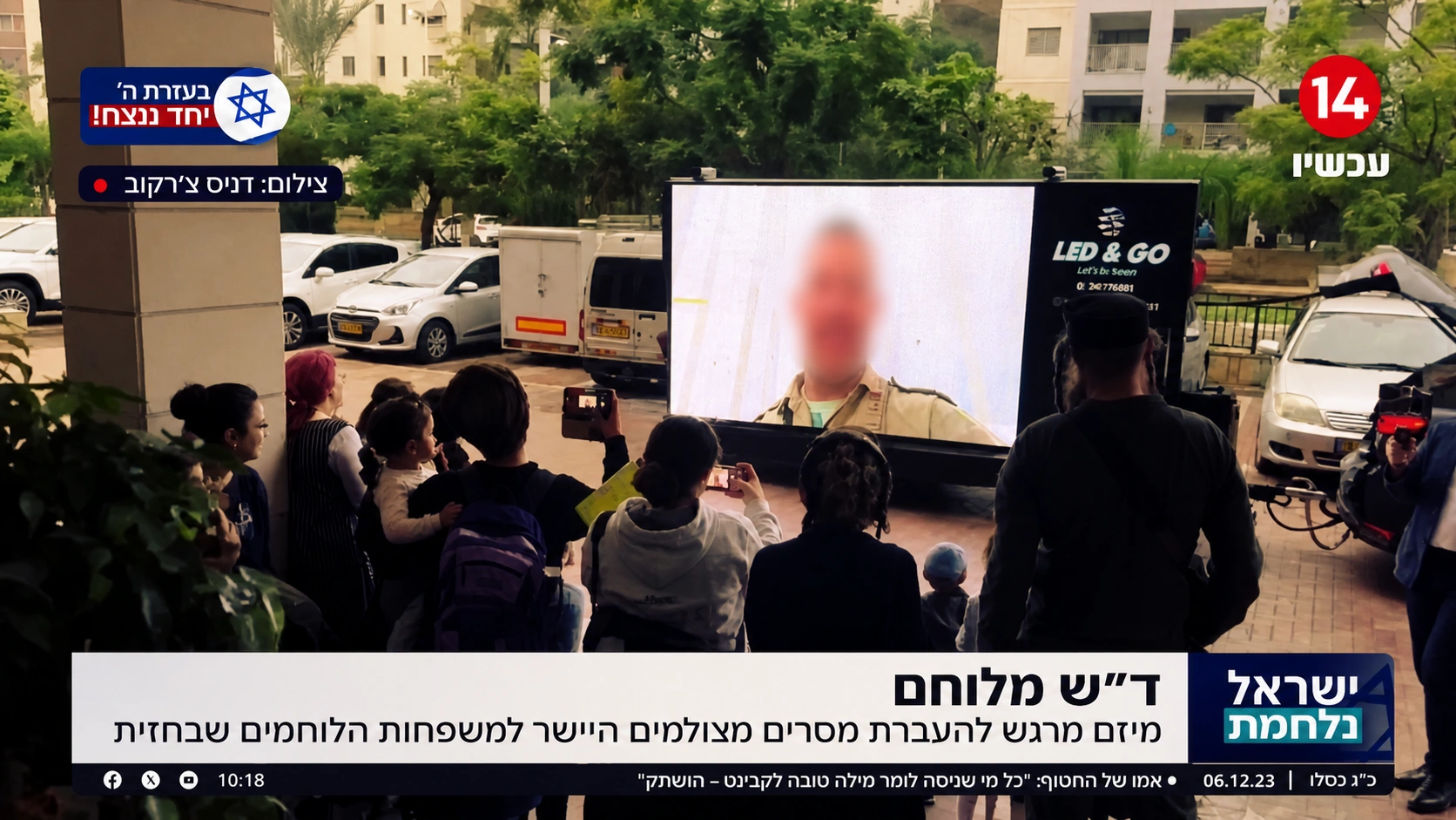 משפחות צופות במסך המציג ברכה מחייל שפניו מטושטשות
